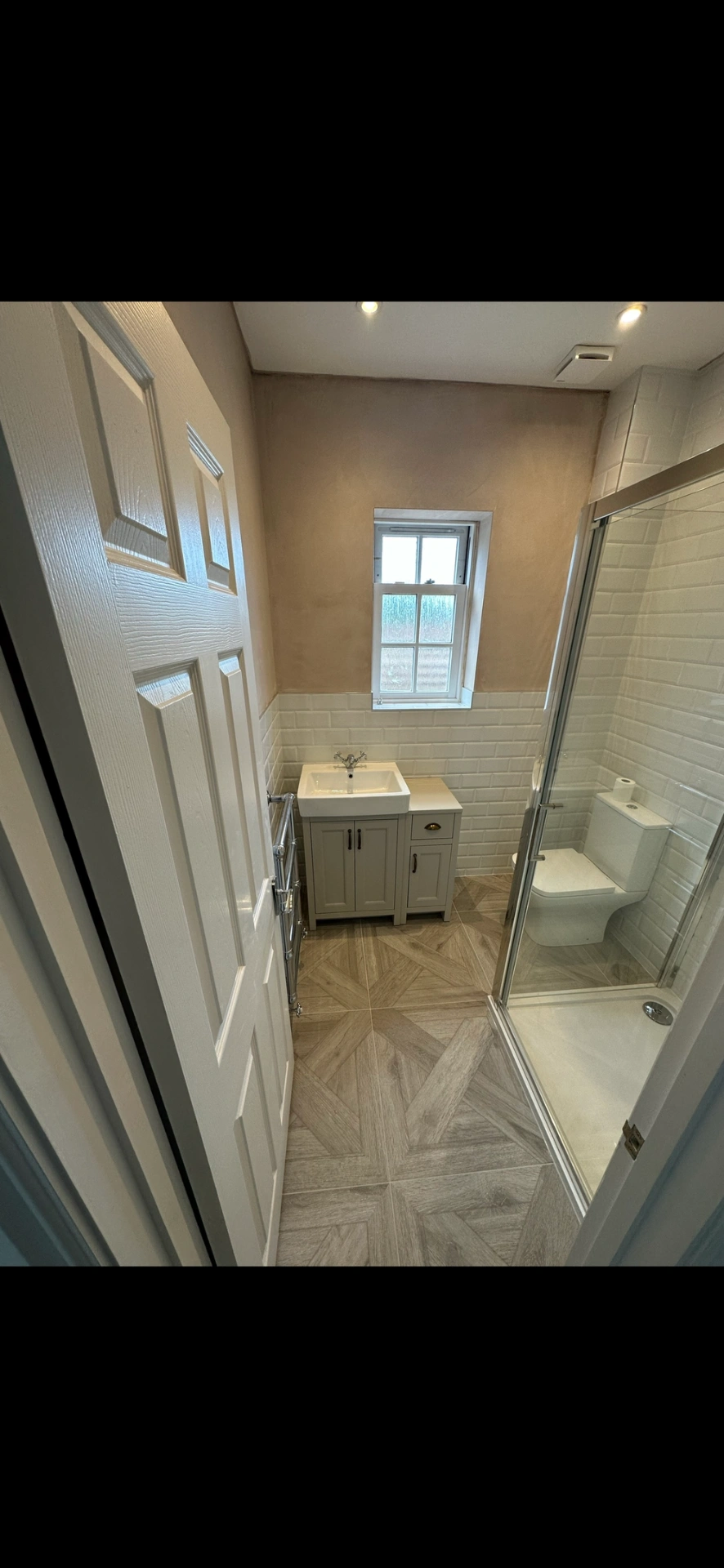 Traditional shower room with chevron wood floor and shaker vanity