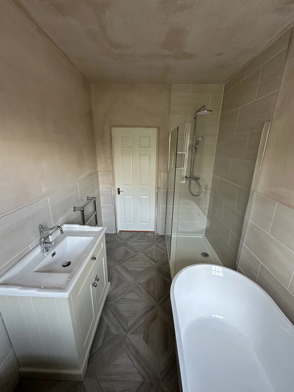 Shaker-style vanity, freestanding bath and walk-in shower with sash window