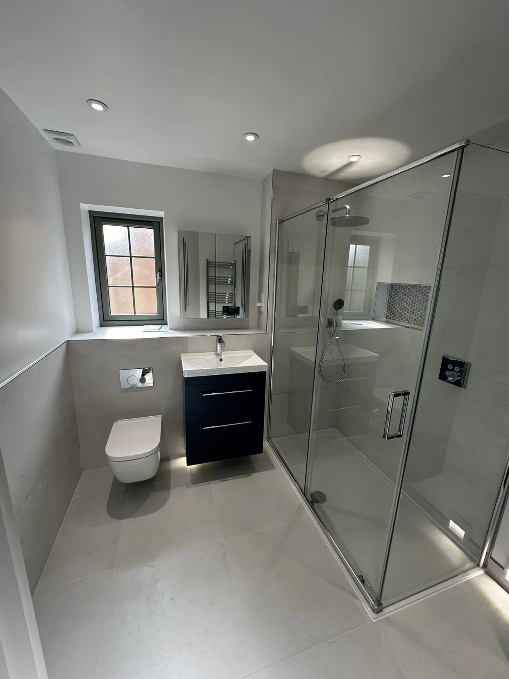 Contemporary bathroom with large walk-in shower and navy vanity